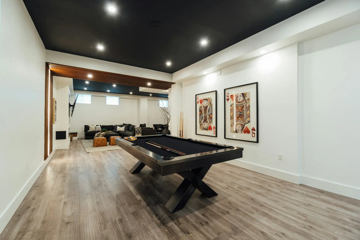 Contemporary luxury billiards room with a black pool table and lounge seating